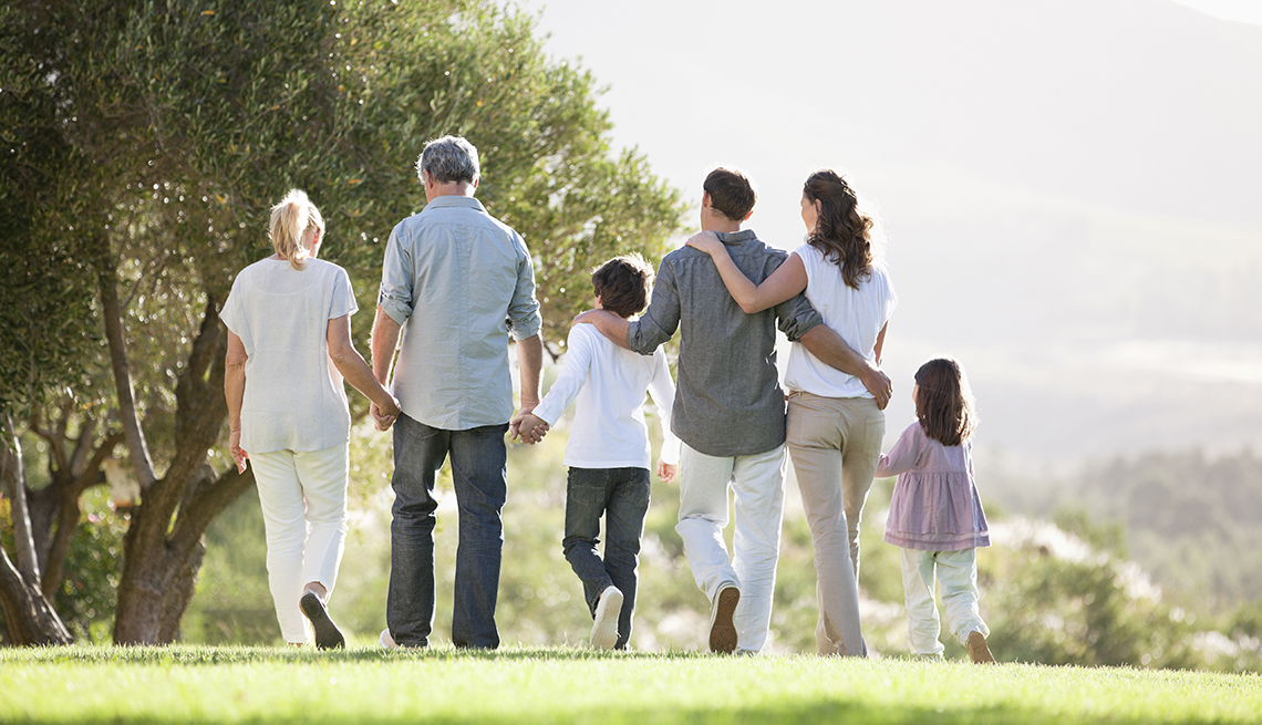 multi-generational family walking in a park