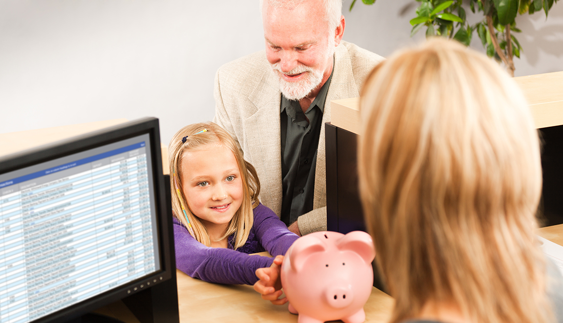 little girl with grandfather at bank to open first account