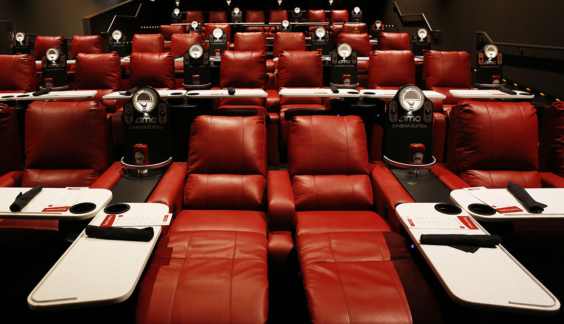 item 4 of Gallery image - Reclining theater seats with pivoting dining trays are among the amenities in AMC's Dine-In Theatre at Block 37 in downtown Chicago. 
