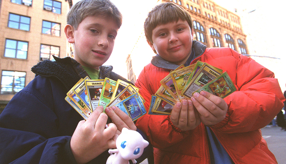 item 7 of Gallery image - two children standing in street display collectible pokemon trading cards