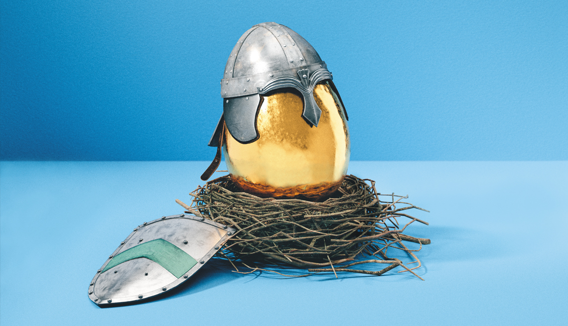 a golden egg with a shield and a helmet in a nest