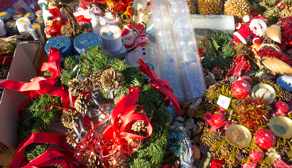 bright red assortment of Christmas ornaments on a yard sale table