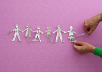 cutting out a string of paper people