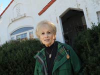In this Nov. 1, 2010 photograph, Robin Miles, 70, stands outside her Baltimore home. About a year ago, Miles got a reverse mortgage on the three-bedroom Spanish-style house.