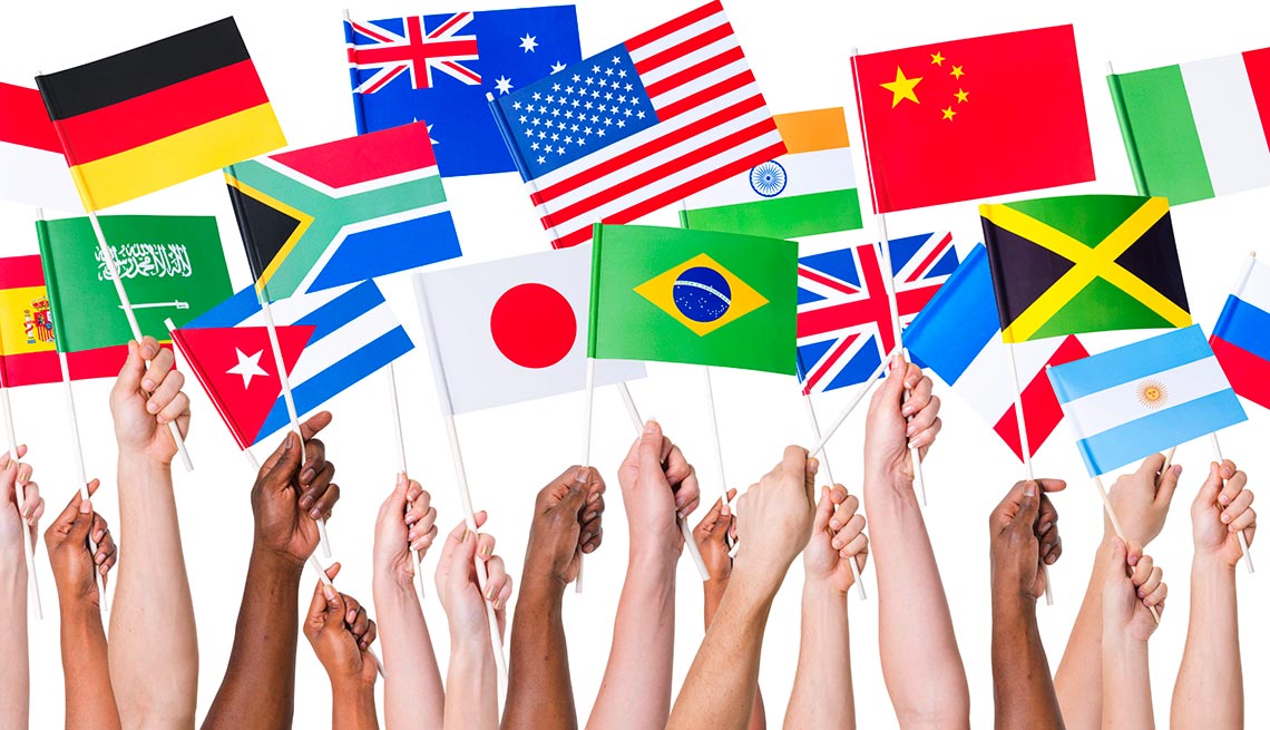 hands holding international flags - investing international 
