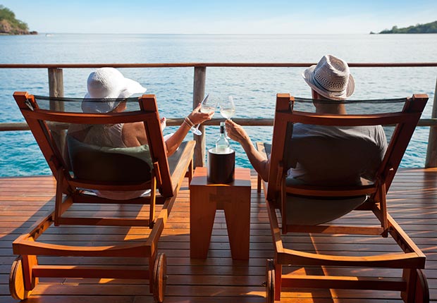 Couple relaxing in an over water bungalow (Getty Images)