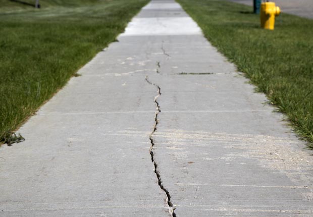 Fix cracks in driveway and sidewalks.  $100 or less DIY home fixes. (Joe Fox/Getty Images)
