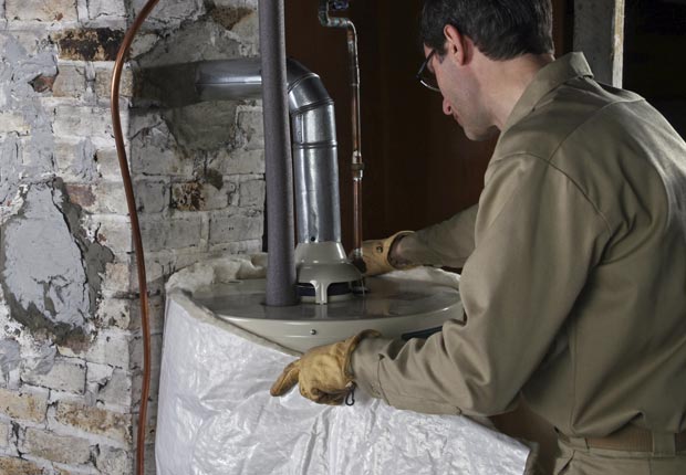 Worker Installing Hot Water Heater Blanket