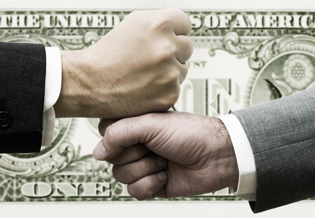 Two businessmen bump fists, Business loans are bad to co-sign