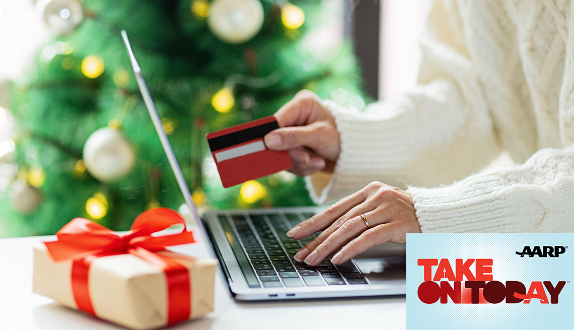 A woman is using a computer to shop online while holiday a credit card