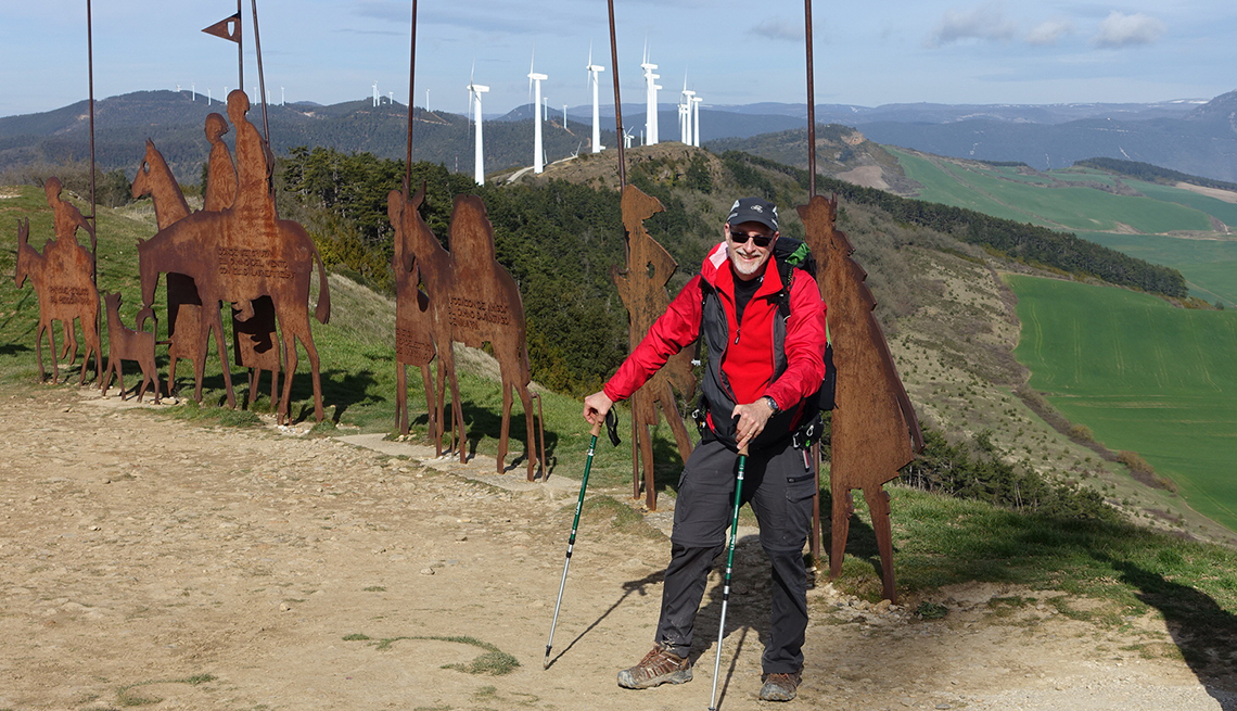 russ eanes stands on the camino de santiago trail with hiking poles
