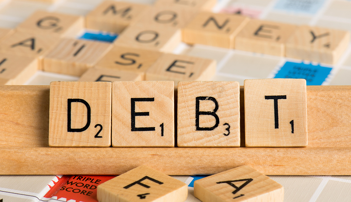 Scrabble letters spell out the word debt