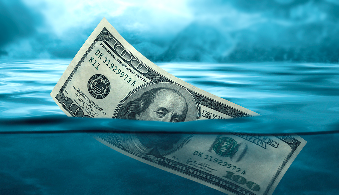 a $100 bill half underwater 