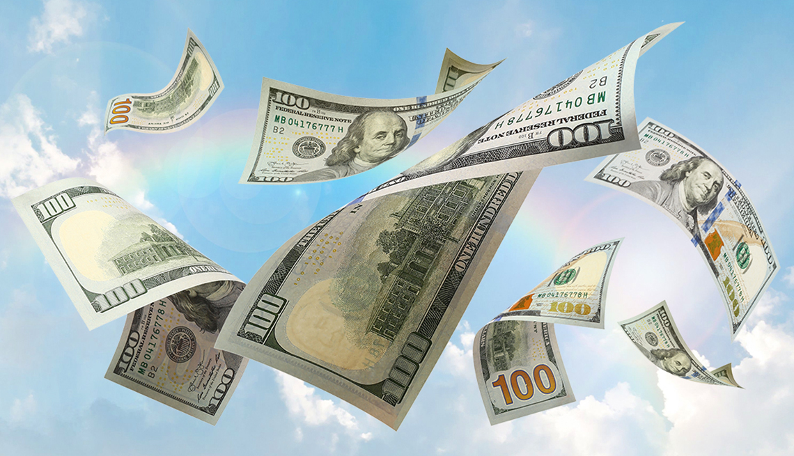 flying hundred dollar bills in the sky with a rainbow behind them