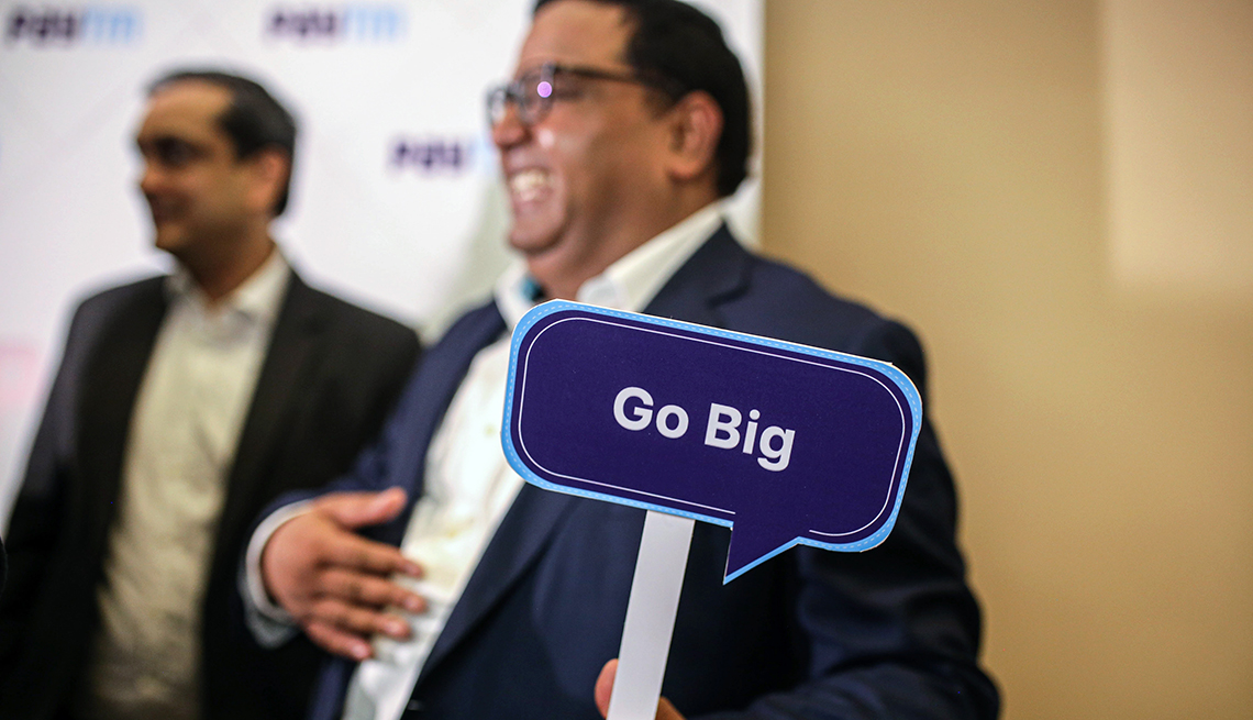 Vijay Shekhar Sharma, founder and chairman of One97 Communications Ltd., operator of PayTM, holds up a sign that says, "Go Big", at the listing ceremony of the company's IPO at the Bombay Stock Exchange in Mumbai, India, on Thursday, Nov. 18, 2021.