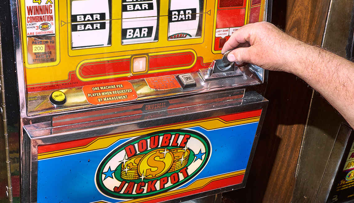 A gambler plays a slot machine at a casino 