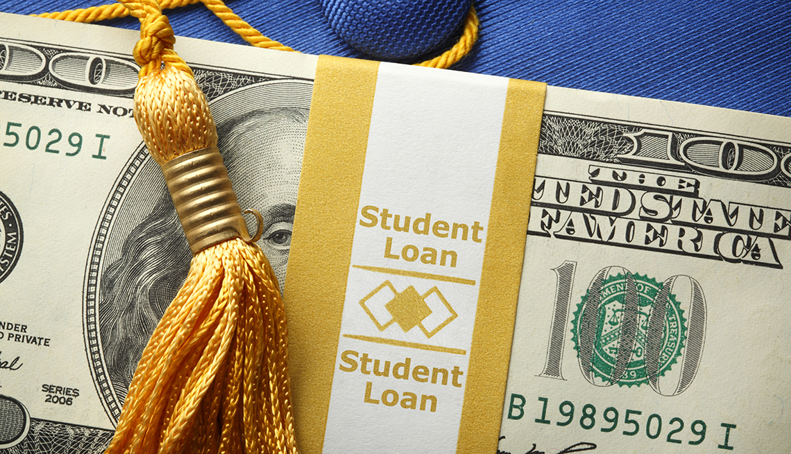 Una pila de billetes de cien dólares en una envoltura de dinero etiquetada como préstamo estudiantil