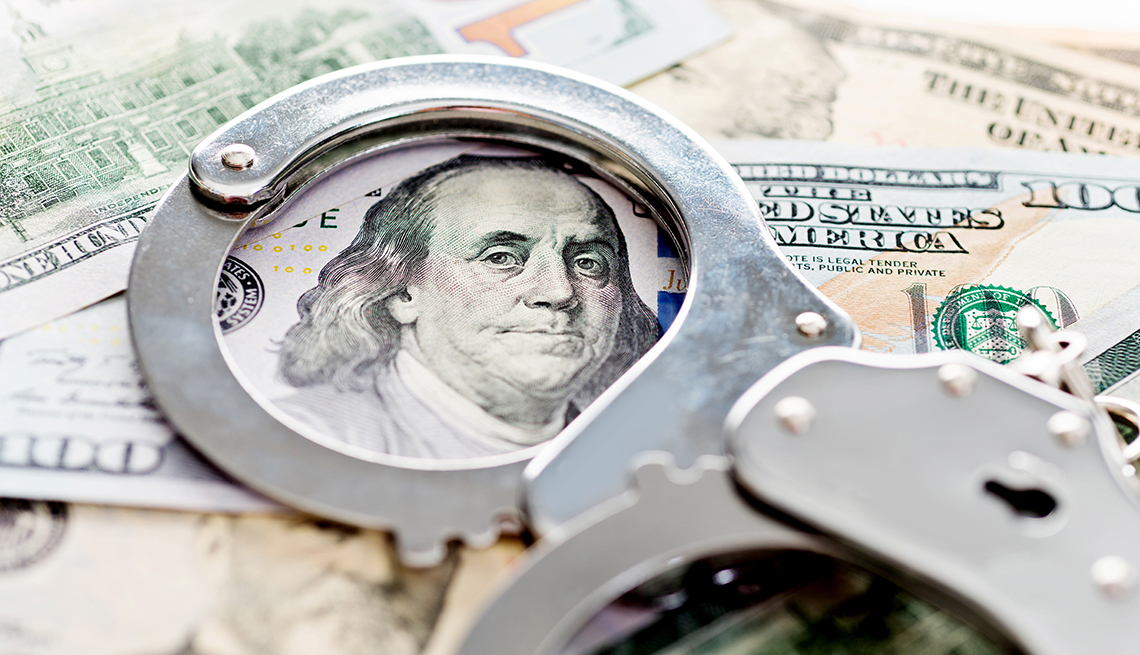 Handcuffs, money fraud concept