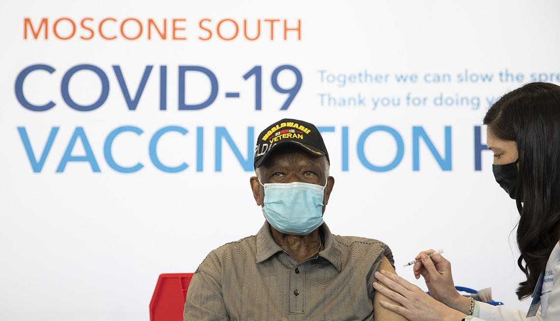 Ezekiel Logan, a 96-year-old World War II veteran, receives his first dose of the Pfizer COVID-19 vaccine