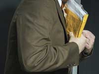 Man carrying envelope - scam artists file phony electronic tax returns to collect return money