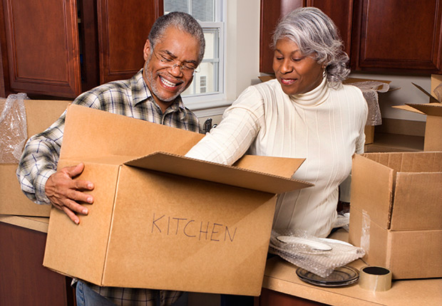 Middle-aged couple unpacking boxes, Writing off job hunt expenses