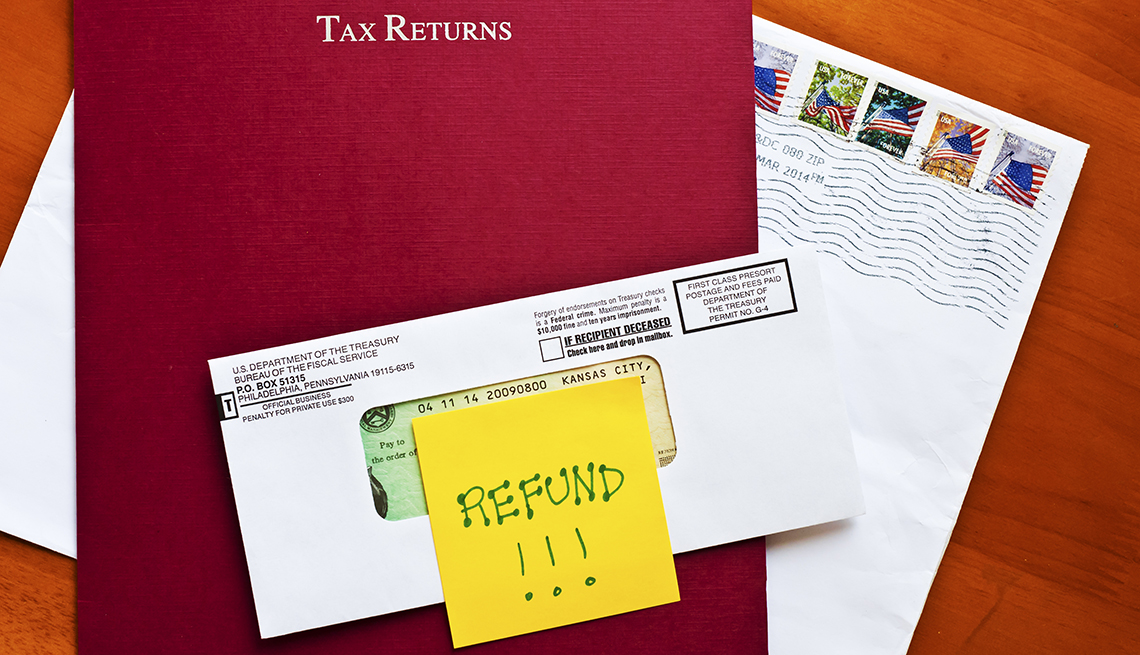 Federal Tax Refund noted on post-it on red paper file cover of a tax returns mailed from preparer
