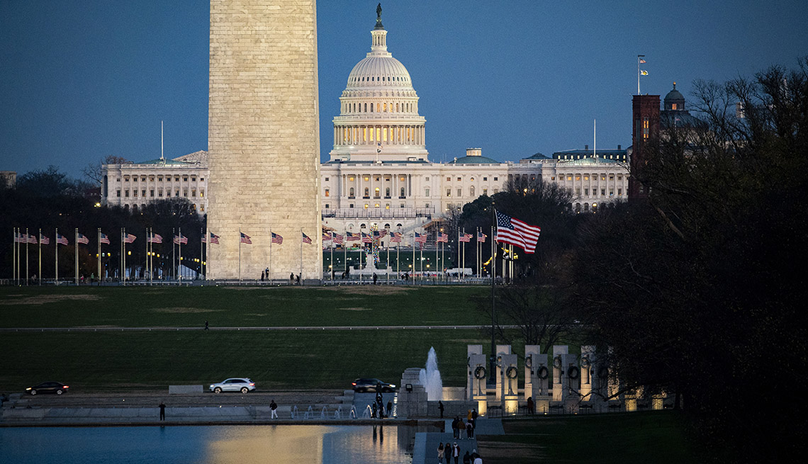Panorama of Reflecting Pool on the National Mall, near the U.S. Capitol and Washington Monument, as the sun sets on December 6, 2020 in Washington, DC.