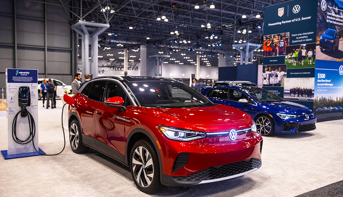 a red electric SUV is on display at an auto show