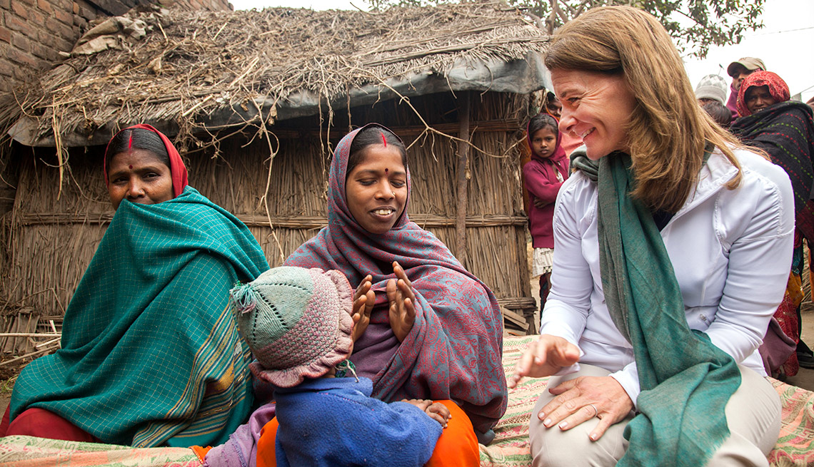 Melinda Gates interacts with Sharmila Devi, who has recently given birth to a girl (carried under her shawl), at her home in Dedaur village in Bakhtiarpur block of Patna district. 
