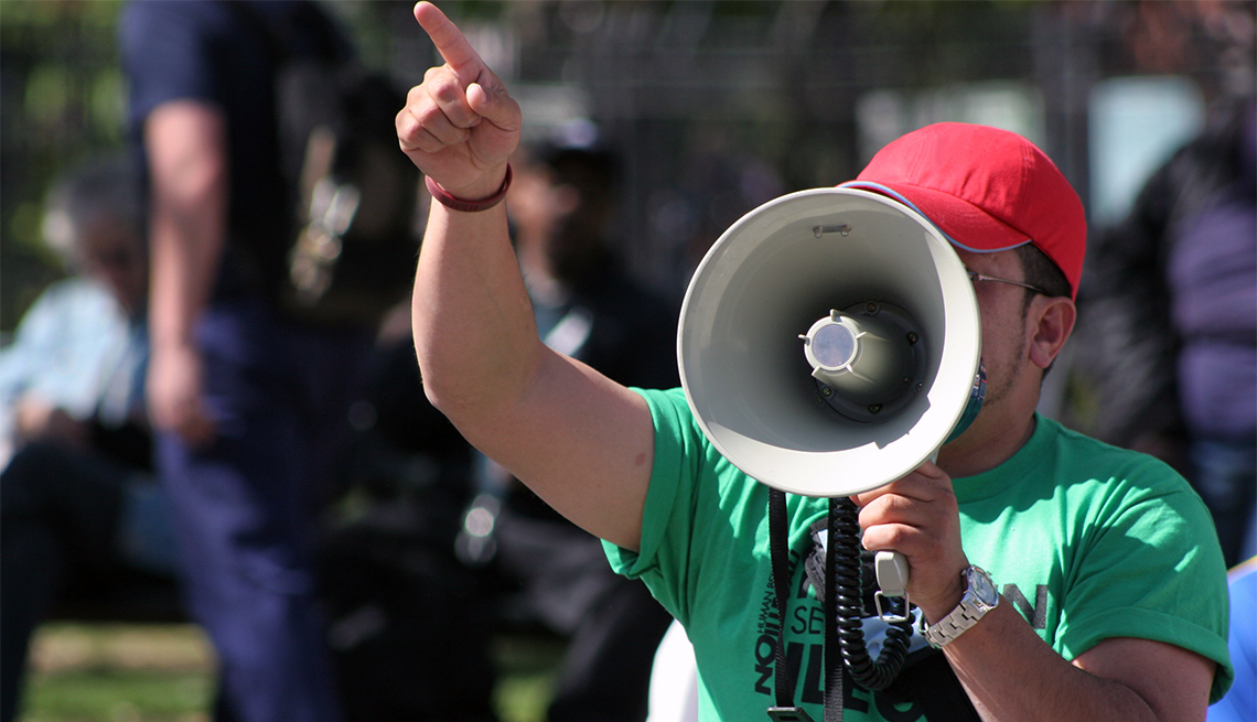 Protester pointing finger and holding megaphone