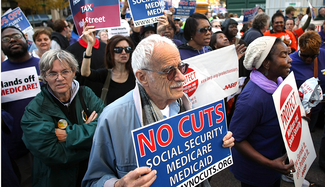 A group of people attend a rally about protecting Medicare, Medicaid and Social Security
