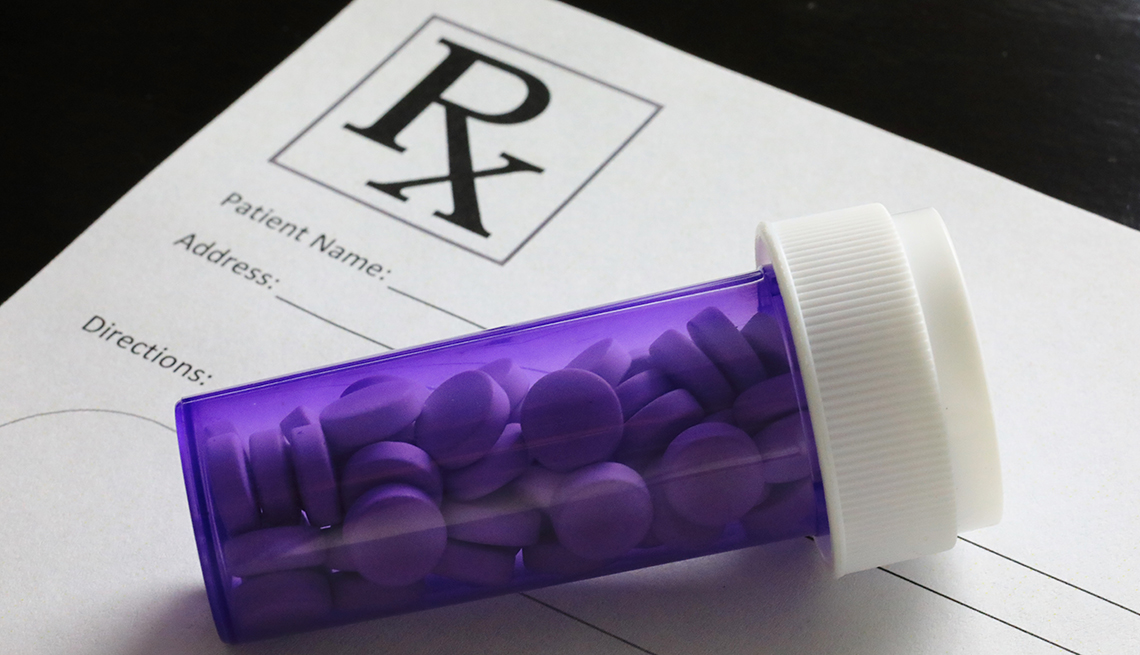 Bottle of pills on a prescription drug pad