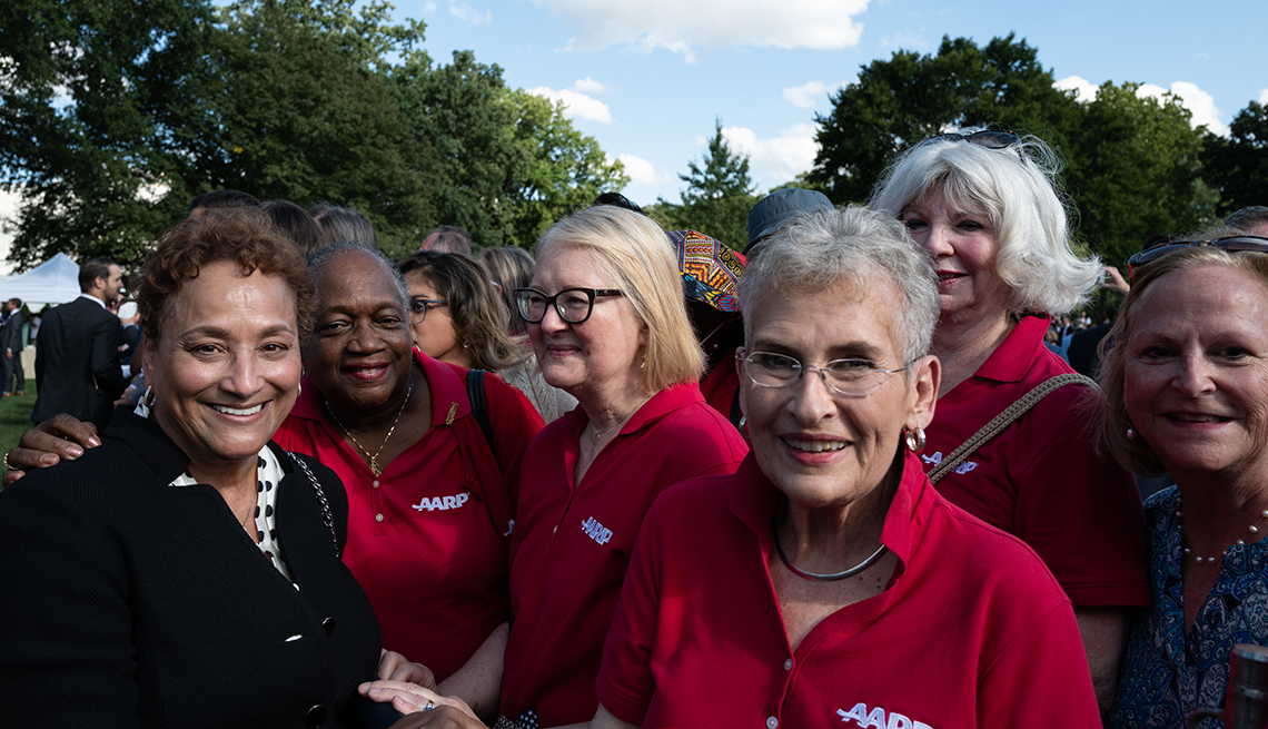 jo ann jenkins stands with aarp volunteers at a white house ceremony