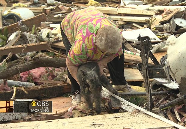 Barbara Garcia was overwhelmed with emotion when her pet dog is discovered just behind her in the rubble of her house as she is being interviewed by CBS News (CBS THIS MORNING)