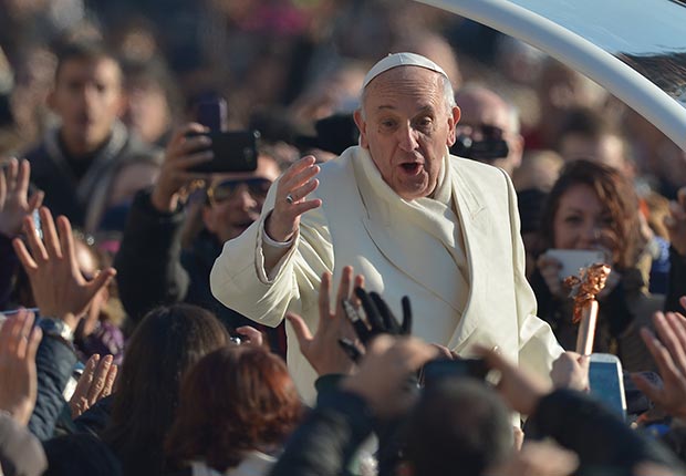 Pope Francis greets the crowd as he arrives for his general audience at St Peter's square. (AFP/Getty Images)