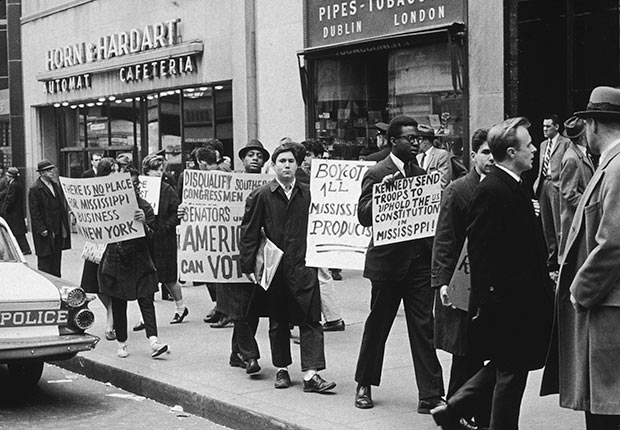 People marching with placards during an anti-segregation demonstration on a sidewalk in front of Horn and Hardart Automat Cafeteria, New York City., Golden Jubilee of the 1964 Civil Rights Act