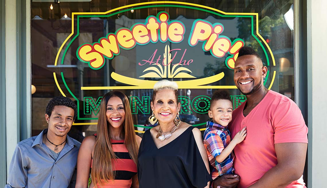 Robbie Montgomery and family in front of one of her restaurants, Sweetie Pie's 