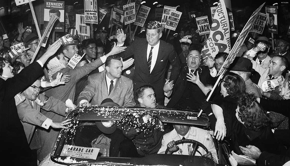 Kennedy campaigns with Chicago's mayor, Richard J. Daley, as supporters swarm his motorcade. 