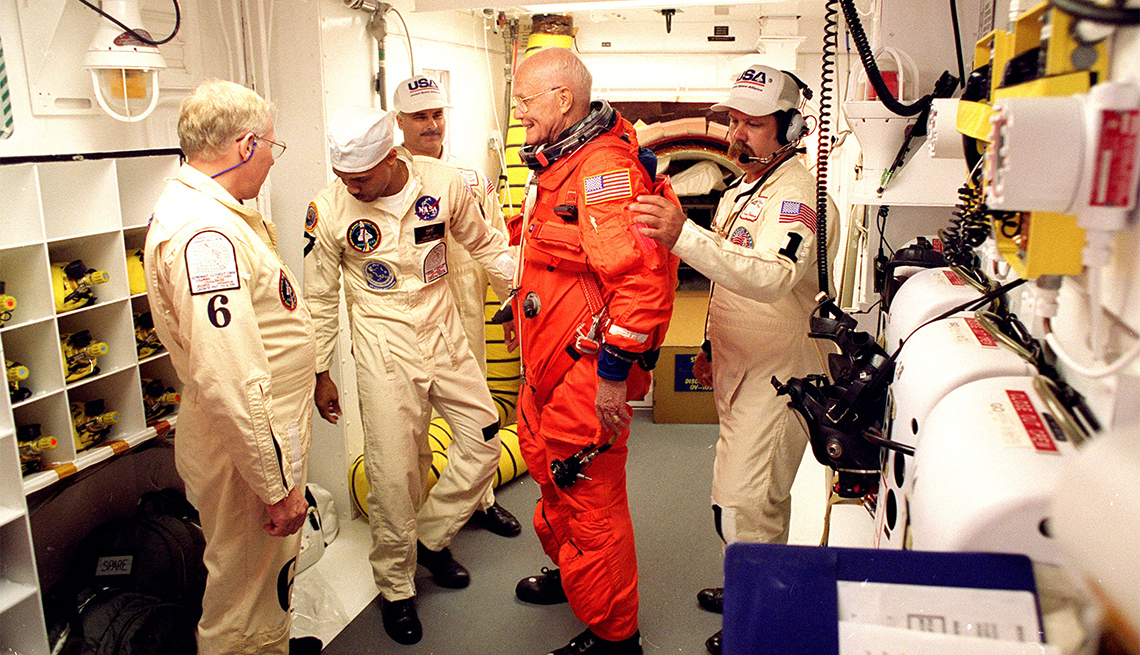 Astronaut Sen. John Glenn being prepared for his return to space mission aboard space shuttle Discovery