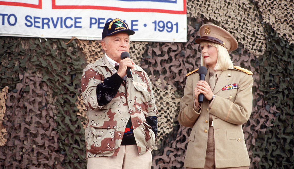 Entertainers Bob Hope and Ann Jillian perform for  military personnel at the USO Christmas Tour during Operation Desert Shield.
