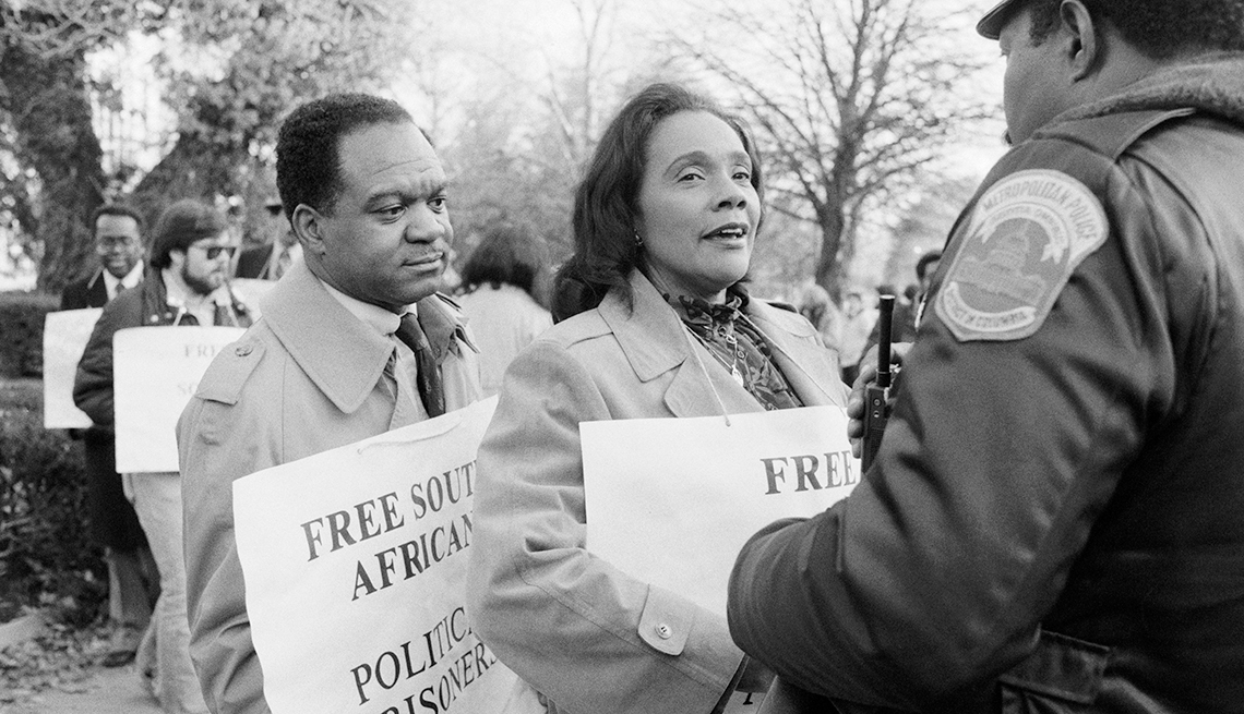 Coretta Scott King y delegado Walter Fauntroy de Washington, DC hablan con un oficial de policía de DC mientras protestaban frente a la embajada de Sudáfrica en 1984.