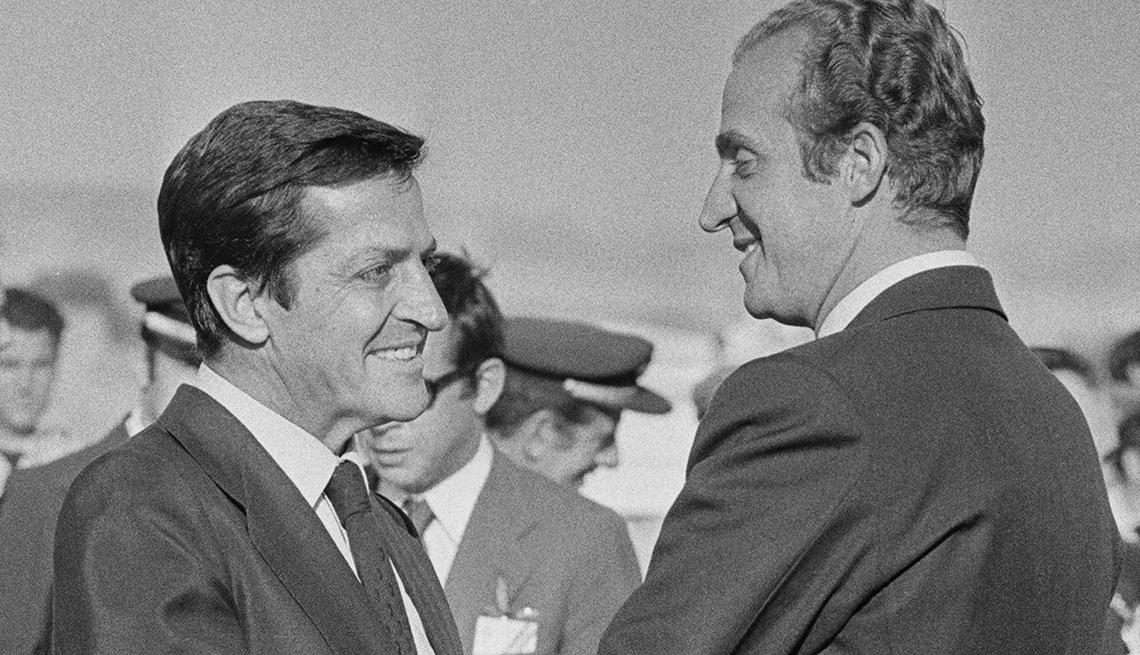 Foto a blanco y negro del rey de España Juan Carlos y Adolfo Suarez saludandose amablemente.