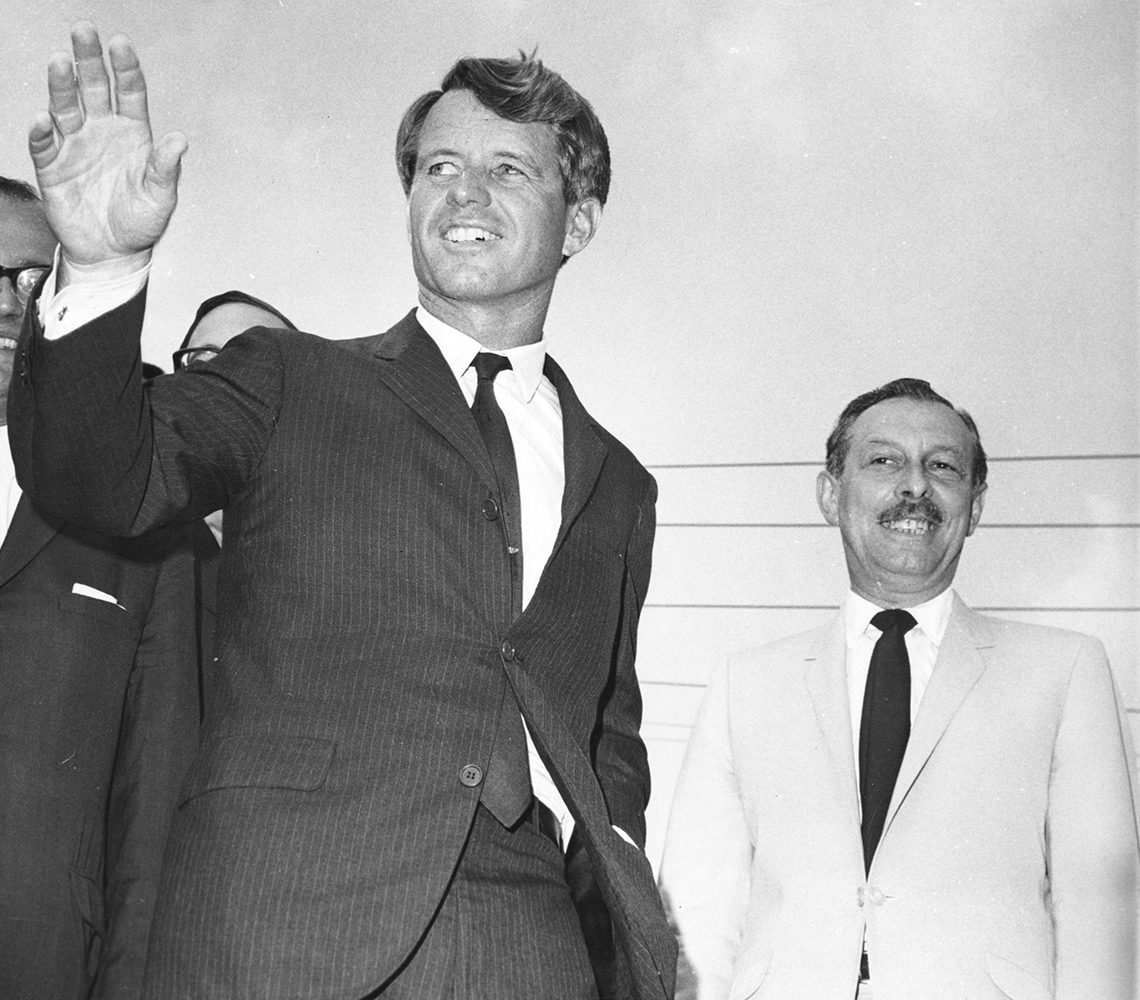 Robert Kennedy waves to a crowd while campaigning for Lester Wolff