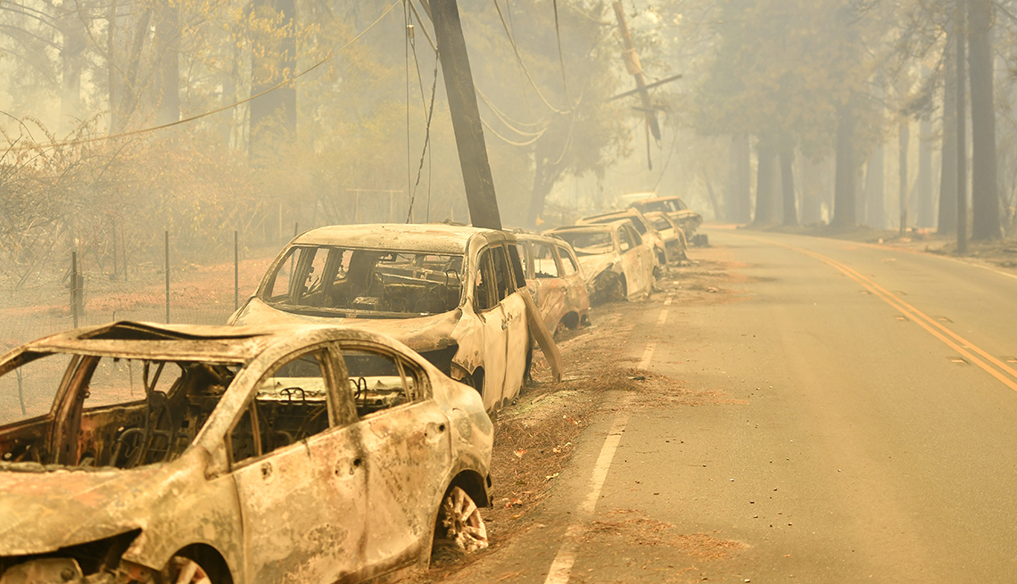 A row of abandon cars line the road after a wildfire
