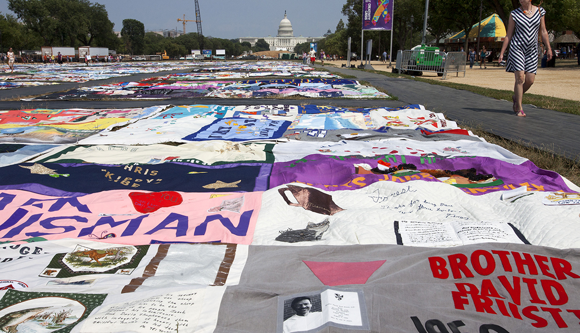 People visit the AIDS Memorial Quilt on display as part of the Smithsonian Folklife Festival on the National Mall in Washington, on Thursday, July 5, 2012. An AIDS-free generation: It seems an audacious goal, considering how the HIV epidemic still is ragi