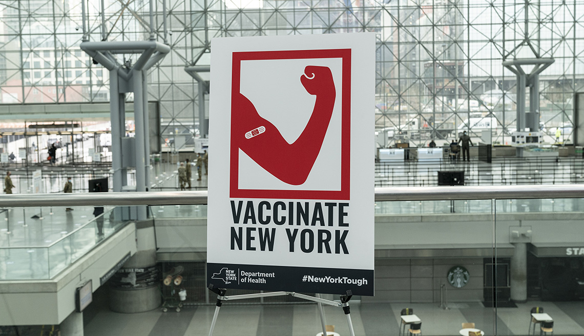 item 8 of Gallery image - sign at mass vaccination site at jacob javits center in new york city saying vaccinate new york
