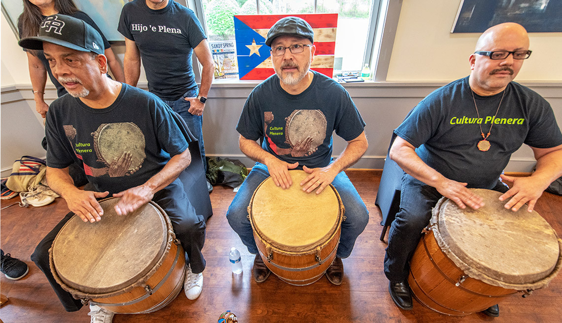 Three Maryland musicians play drums and sing to enjoy the music and dance of Cultura Planera, a Puerto Rican bomba y plena tradition