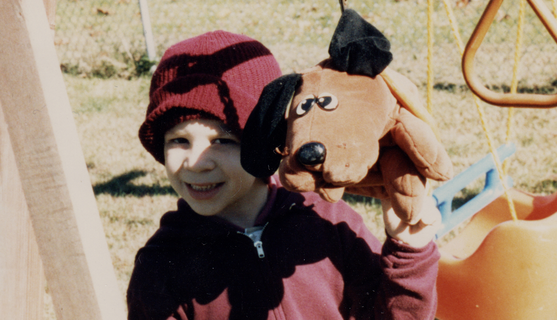 Niño con un juguete con figura de perro en la mano