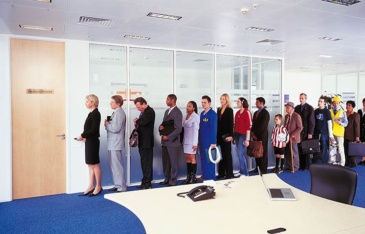 Long line of people waiting outside an office
