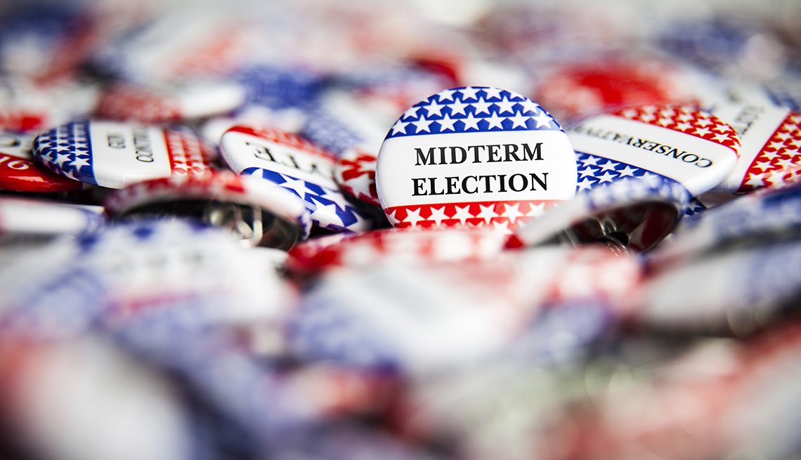 red white and blue buttons with the word midterm election on one of them